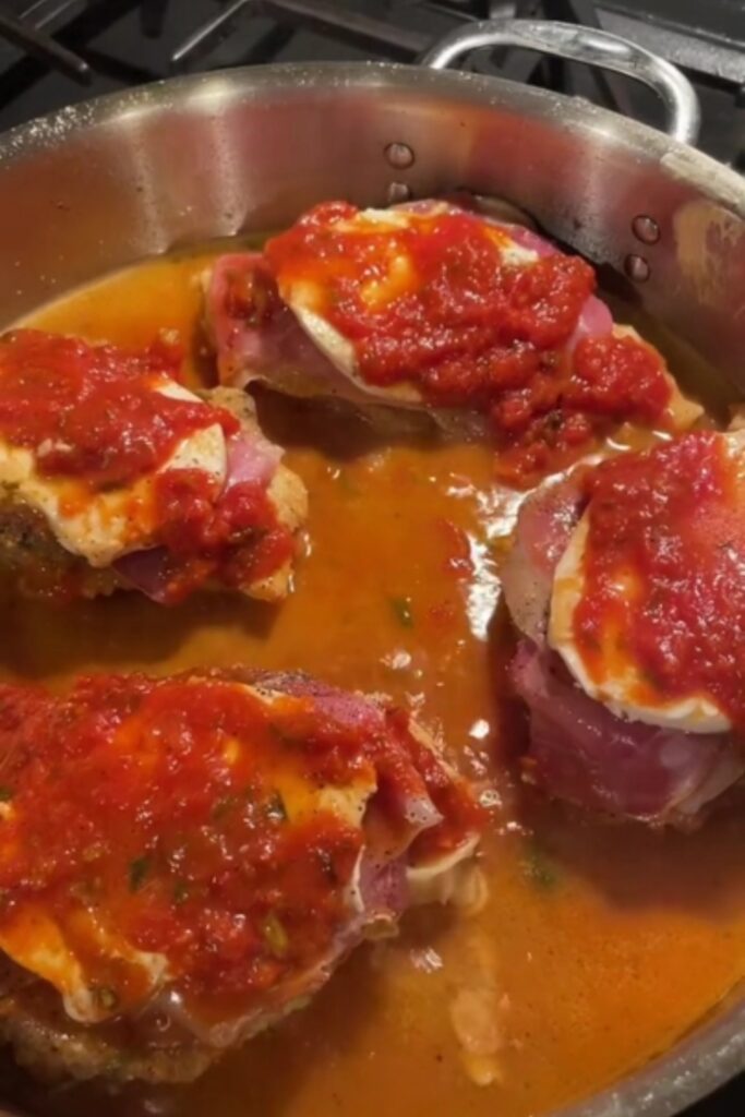 Giada De Laurentiis Chicken Sorrentino in a pan with tomato sauce and mozzarella.