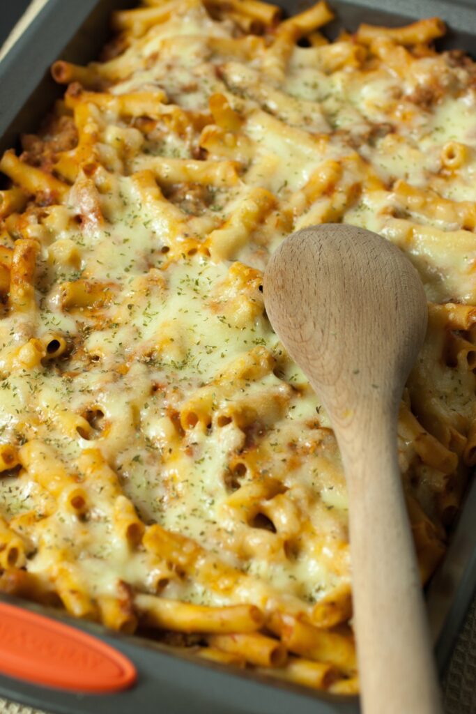 Giada De Laurentiis Baked Lemon Ziti in a baking dish with melted cheese on top.