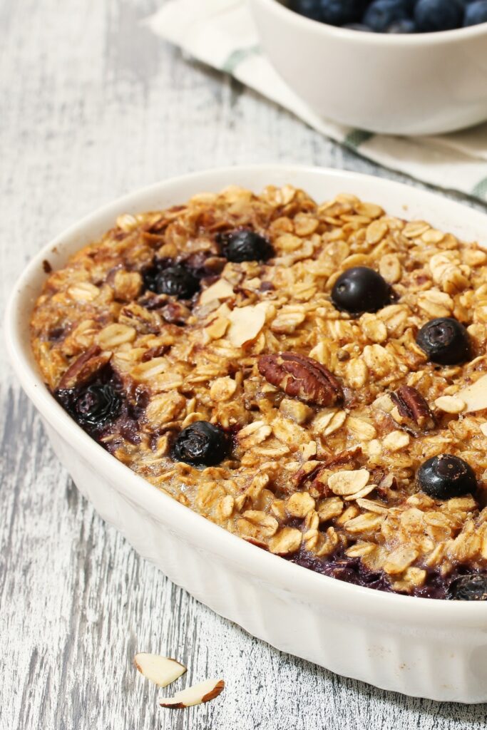 Giada De Laurentiis baked oatmeal with blueberries and pecans in a white dish.