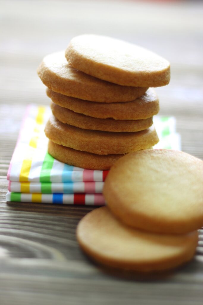 Plate of Giada De Laurentiis Butter Cookies with a plant in the background.