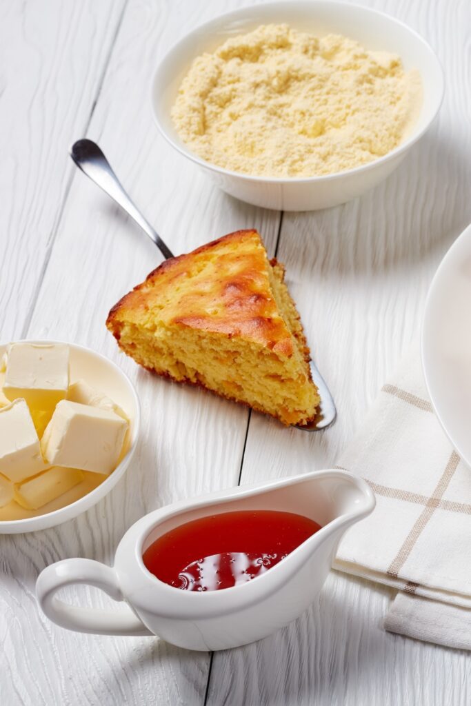 Slice of Giada De Laurentiis Buttermilk Cornbread with butter and honey.