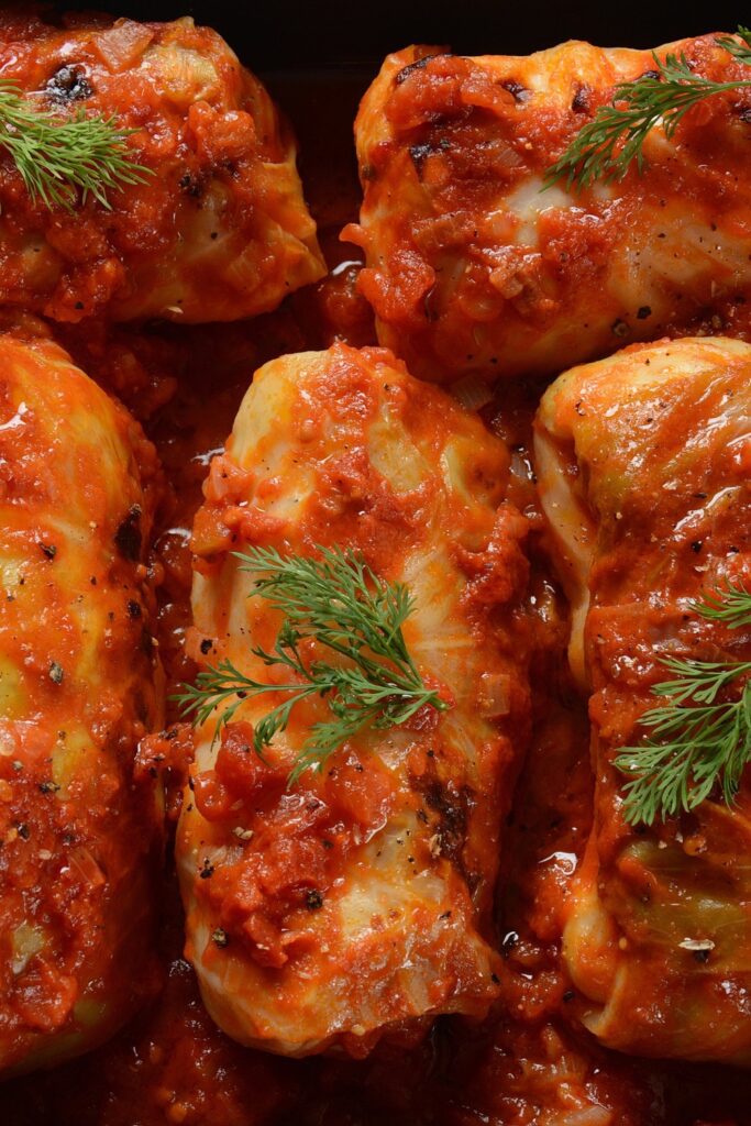 Giada De Laurentiis Cabbage Rolls in tomato sauce garnished with dill.