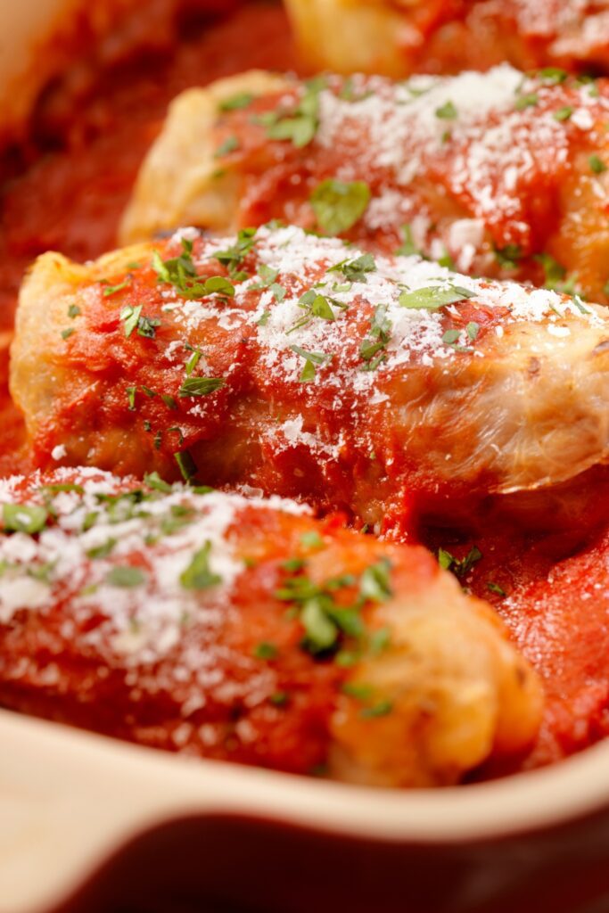 Giada De Laurentiis Cabbage Rolls topped with tomato sauce and parsley.