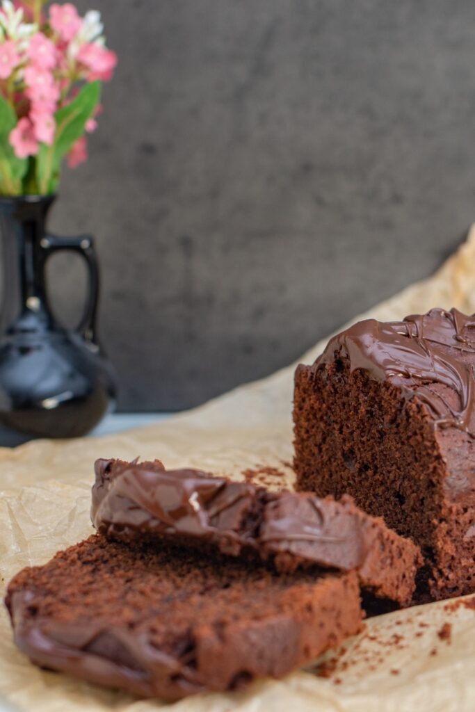 Sliced chocolate mascarpone pound cake with chocolate glaze.