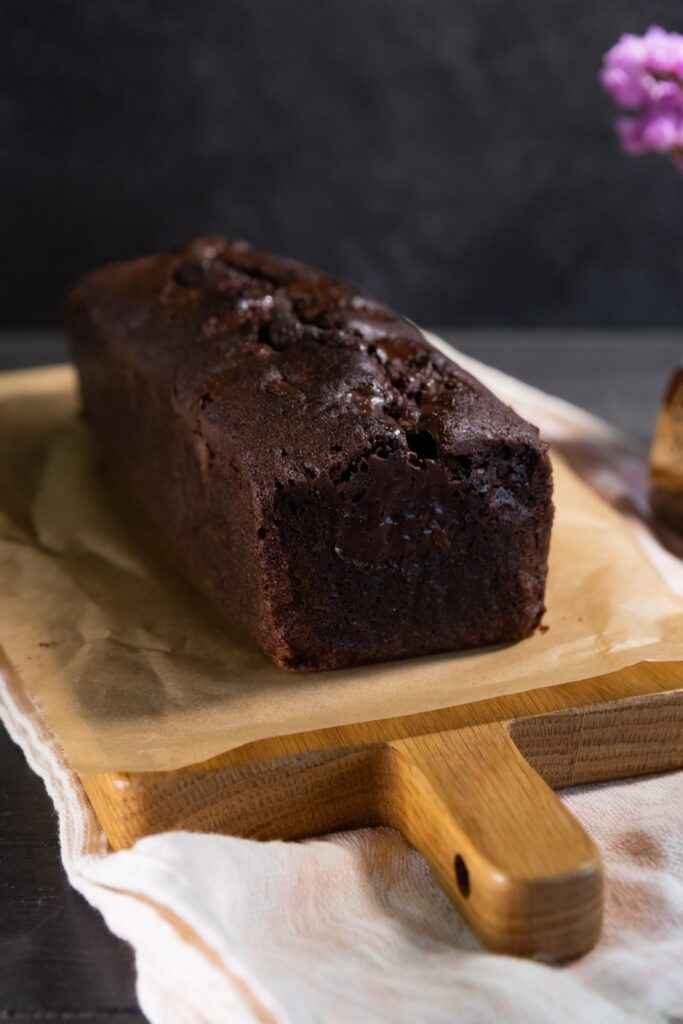 Chocolate mascarpone pound cake on a wooden cutting board.